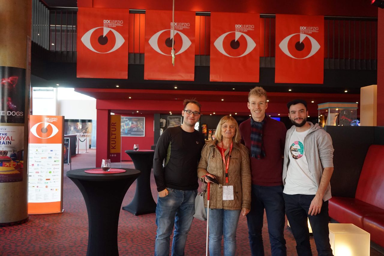 Die Blindgängerin mit drei jungen Männern im Foyer des Kinos Cinestar in Leipzig